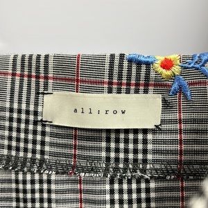 All Row tweed pleated dress with salvaged straps and embroidered flowers.